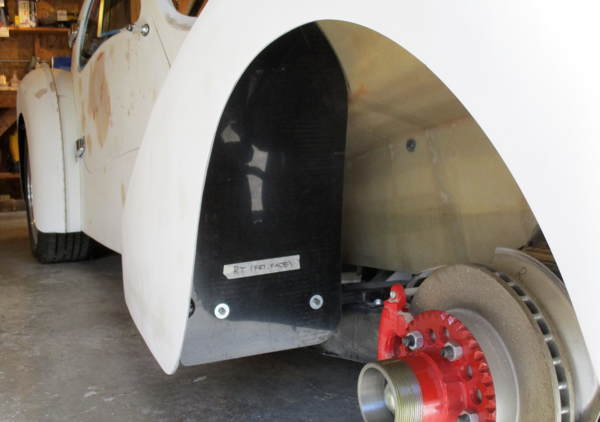 Splash shield screws to the fender brace bar